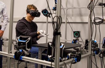 Facebook CEO Mark Zuckerberg tours an Oculus research lab