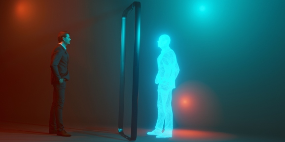 Concept image of man looking at his own digital twin mirrored through the frame of a mobile phone.  His twin is an avatar looking like a hologram.